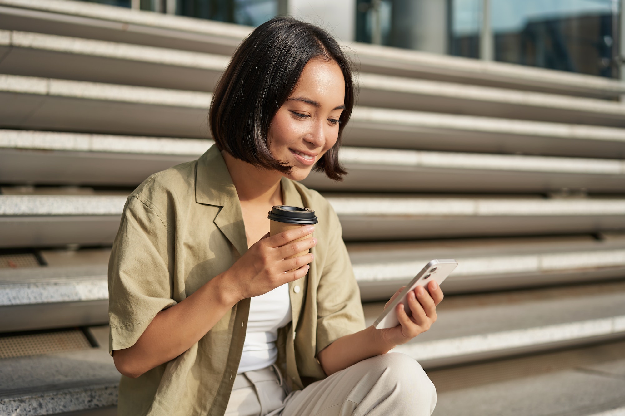Woman with coffee checking her trading app